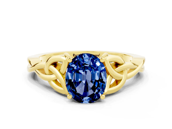 Yellow gold Oval Cut Blue Sapphire Solitaire Engagement Ring with Celtic Knot Band and Four-Prong Setting