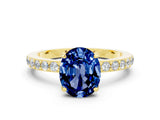 Yellow gold Oval Cut Blue Sapphire Solitaire Engagement Ring with Pavé Band and Four-Prong Setting