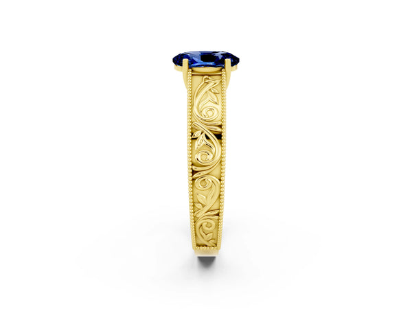 Yellow gold Oval Cut Blue Sapphire Solitaire Ring with Engraved Band and Four-Prong Setting