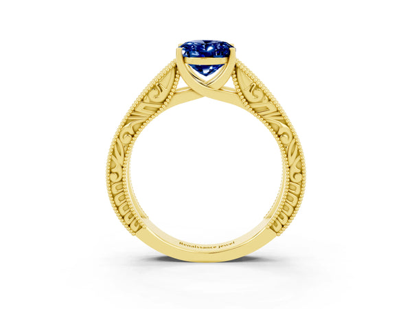 Yellow gold Oval Cut Blue Sapphire Solitaire Ring with Engraved Band and Four-Prong Setting