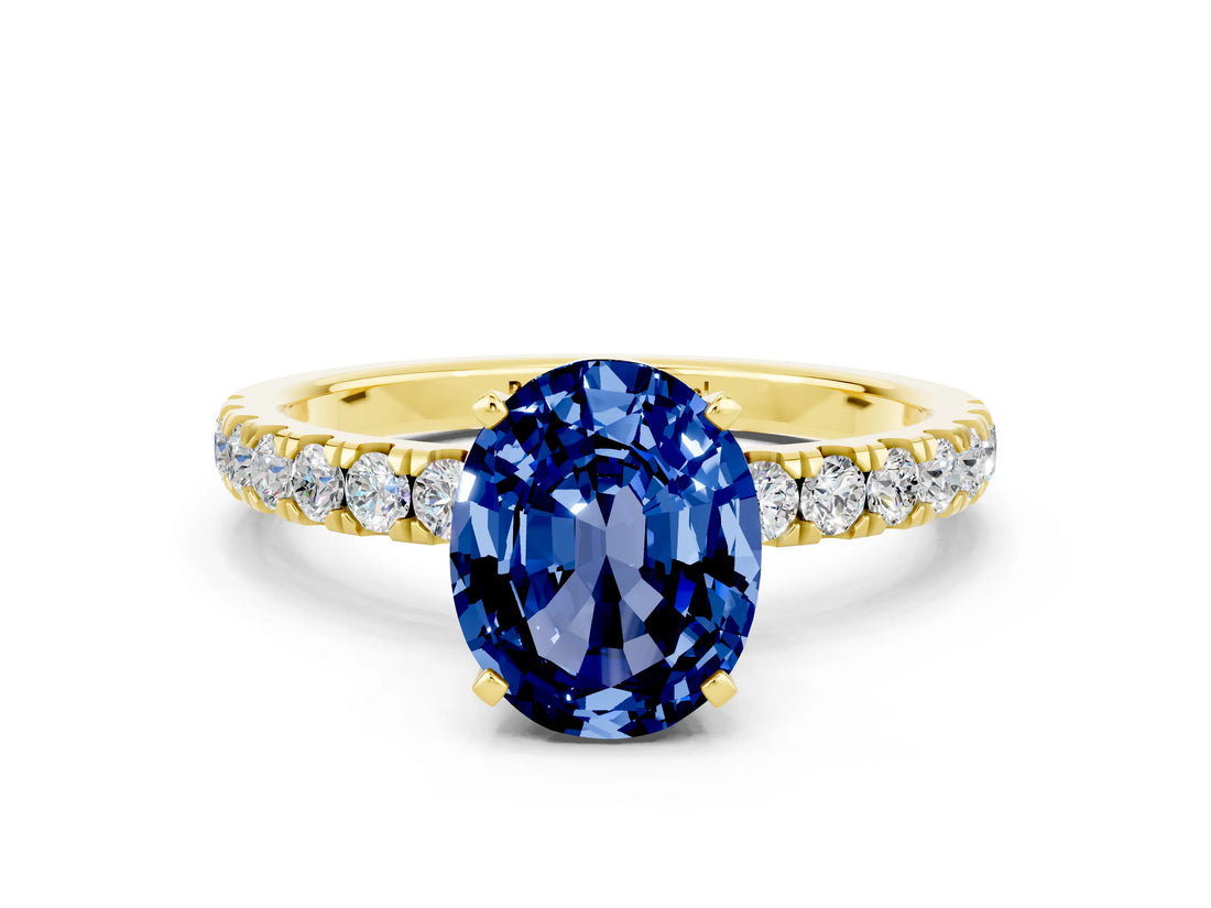 Yellow gold Oval Cut Blue Sapphire Solitaire Ring with Pavé Accents and Four-Prong Setting