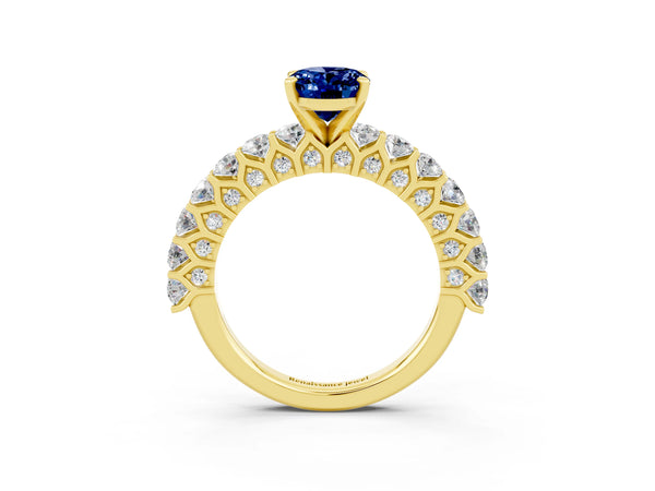Yellow gold Oval Cut Blue Sapphire Solitaire Ring with Shared Prong Pavé Band and Four-Prong Setting