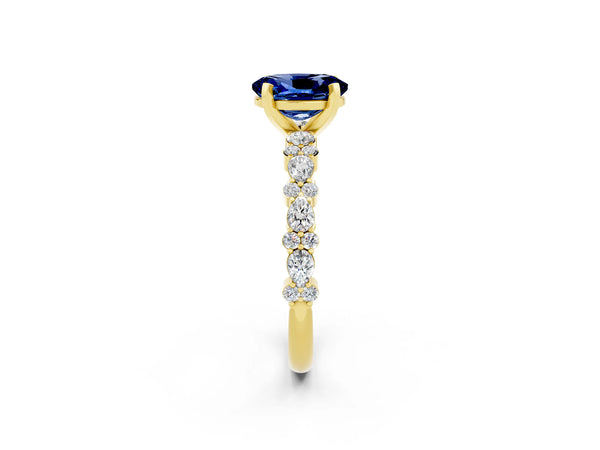 Yellow gold Oval Cut Blue Sapphire Side Stone Solitaire Ring with Round  and Four-Prong Setting
