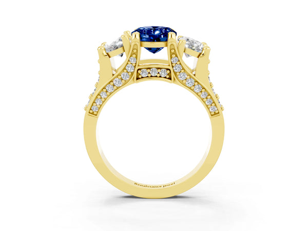 Yellow gold Oval Cut Blue Sapphire Three-Stone Ring with Channel Set Band and Four-Prong Setting