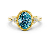 Yellow gold Oval Cut Blue Topaz Halo Ring with Tapered Band and Four-Prong Setting