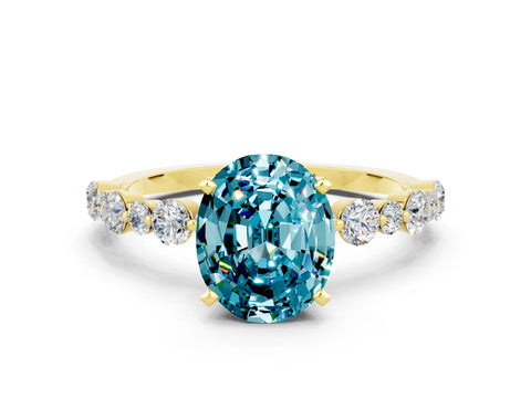 Yellow gold Oval Cut Blue Topaz Prong Set Engagement Ring with Pavé Band