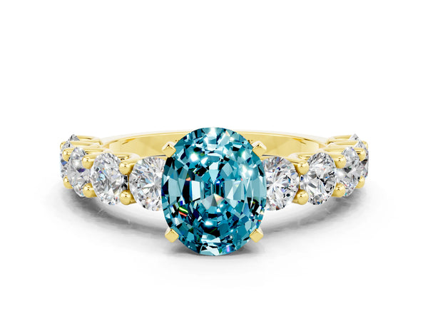 Yellow gold Oval Cut Blue Topaz Prong Setting with Side Stones on a Pave Band