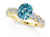 Yellow gold Oval Cut Blue Topaz Prong Setting with Side Stones on a Pave Band_1
