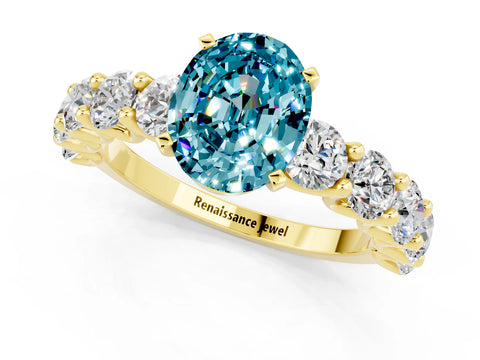 Yellow gold Oval Cut Blue Topaz Prong Setting with Side Stones on a Pave Band_1
