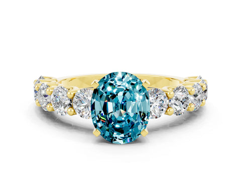 Yellow gold Oval Cut Blue Topaz Prong Setting with Side Stones on a Pave Band
