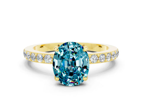 Yellow gold Oval Cut Blue Topaz Ring with Pavé Band and Four-Prong Setting