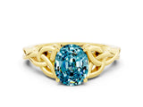 Yellow gold Oval Cut Blue Topaz Solitaire Engagement Ring with Celtic Knot Band and Four-Prong Setting