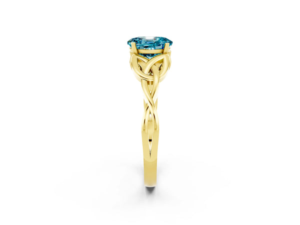 Yellow gold Oval Cut Blue Topaz Solitaire Engagement Ring with Celtic Knot Band and Four-Prong Setting