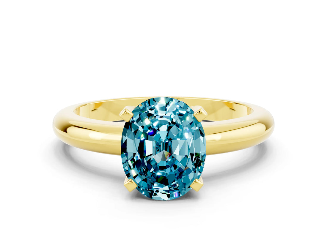 Yellow gold Oval Cut Blue Topaz Solitaire Engagement Ring with Round Band and Four-Prong Setting