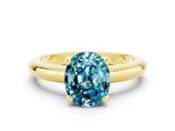 Yellow gold Oval Cut Blue Topaz Solitaire Engagement Ring with Round Band and Four-Prong Setting