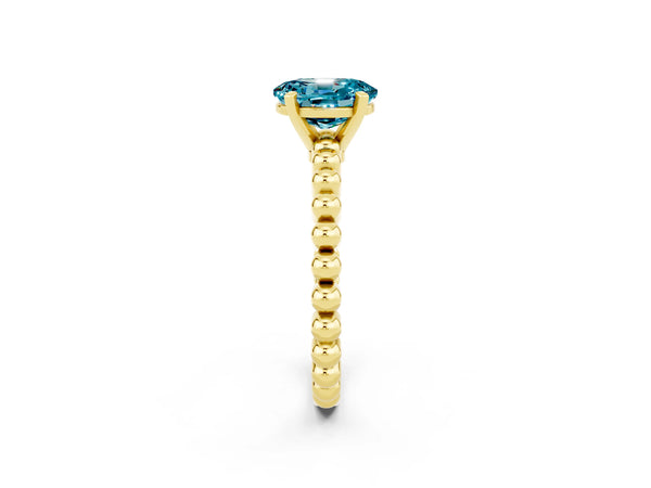 Yellow gold Oval Cut Blue Topaz Solitaire Ring with Beaded Band and Prong Setting