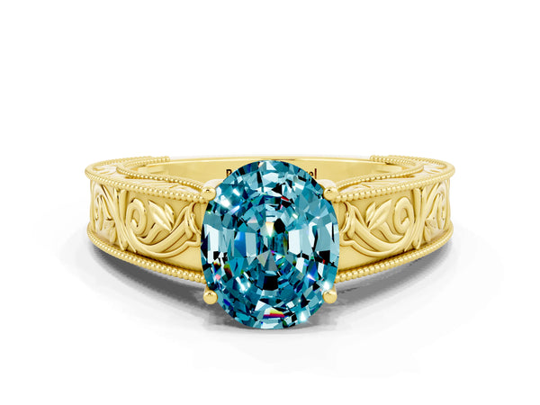 Yellow gold Oval Cut Blue Topaz Solitaire Ring with Engraved Band and Four-Prong Setting