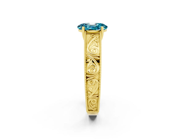Yellow gold Oval Cut Blue Topaz Solitaire Ring with Engraved Band and Four-Prong Setting