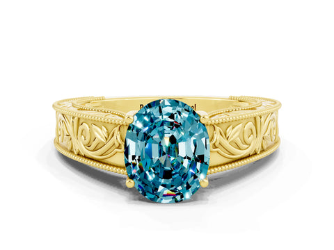 Yellow gold Oval Cut Blue Topaz Solitaire Ring with Engraved Band and Four-Prong Setting