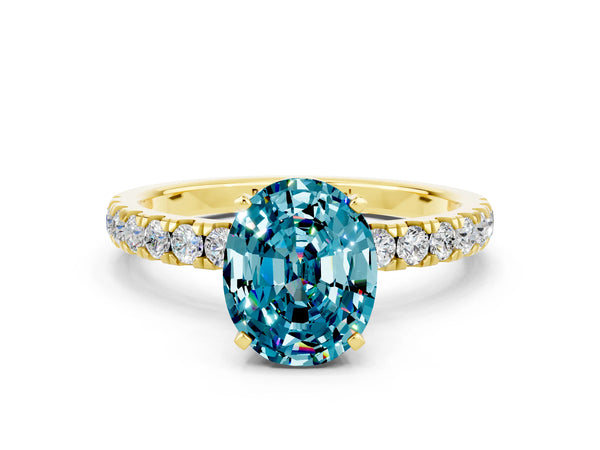 Yellow gold Oval Cut Blue Topaz Solitaire Ring with Pavé Accents and Four-Prong Setting
