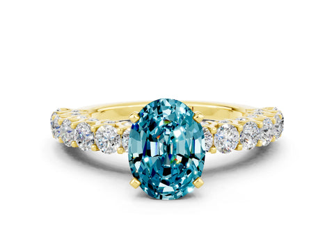 Yellow gold Oval Cut Blue Topaz Solitaire Ring with Shared Prong Pavé Band and Four-Prong Setting