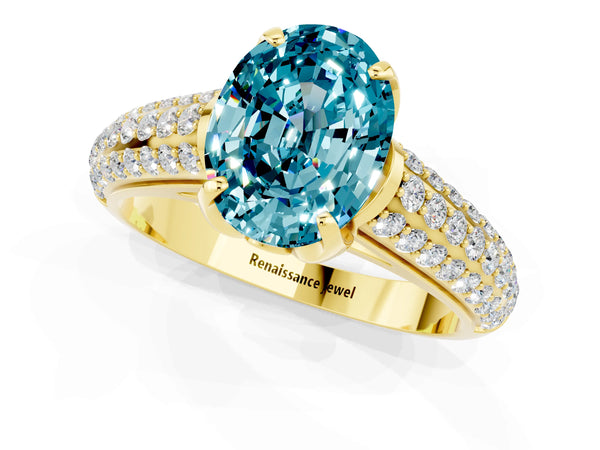 Yellow gold Oval Cut Blue Topaz Solitaire Ring with Three-Row Pavé Band and Four-Prong Setting