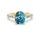 Yellow gold Oval Cut Blue Topaz Solitaire with Side Baguettes and Channel Set Band