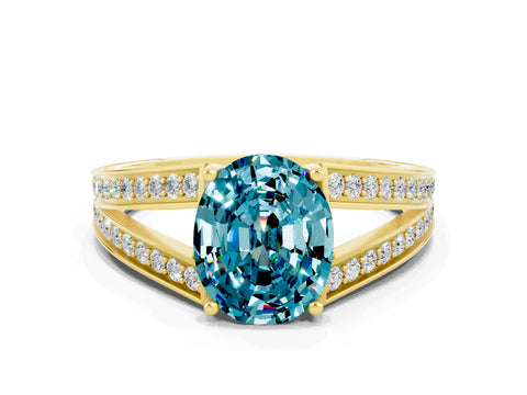 Yellow gold Oval Cut Blue Topaz Split Shank Ring with Pavé Band and Four-Prong Setting