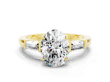 Yellow gold Oval Cut Cut Diamond Ring with Tapered Baguette Side Stones in Four-Prong Setting