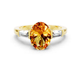 Yellow gold Oval Cut Cut Diamond Ring with Tapered Baguette Side Stones in Four-Prong Setting