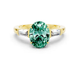 Yellow gold Oval Cut Cut Diamond Ring with Tapered Baguette Side Stones in Four-Prong Setting