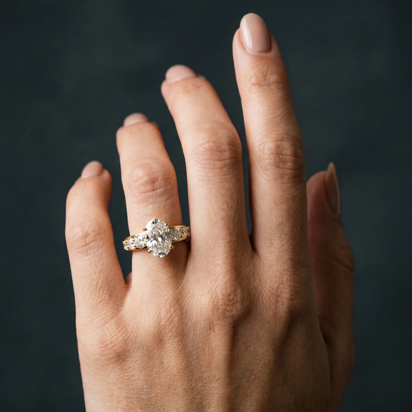 Yellow gold Oval Cut Diamond Engagement Ring with Pavé Band and Four-Prong Setting