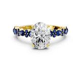 Yellow gold Oval Cut Diamond Side Stone Solitaire Ring with Round with Blue Sapphire side stone and Four-Prong Setting