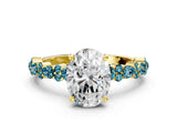 Yellow gold Oval Cut Diamond Side Stone Solitaire Ring with Round with Blue Topaz side stone and Four-Prong Setting
