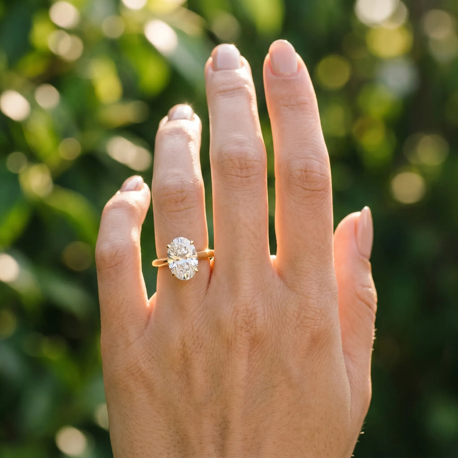 Yellow gold Oval Cut Diamond Solitaire Engagement Ring with Cathedral Setting and Four-Prong Mount