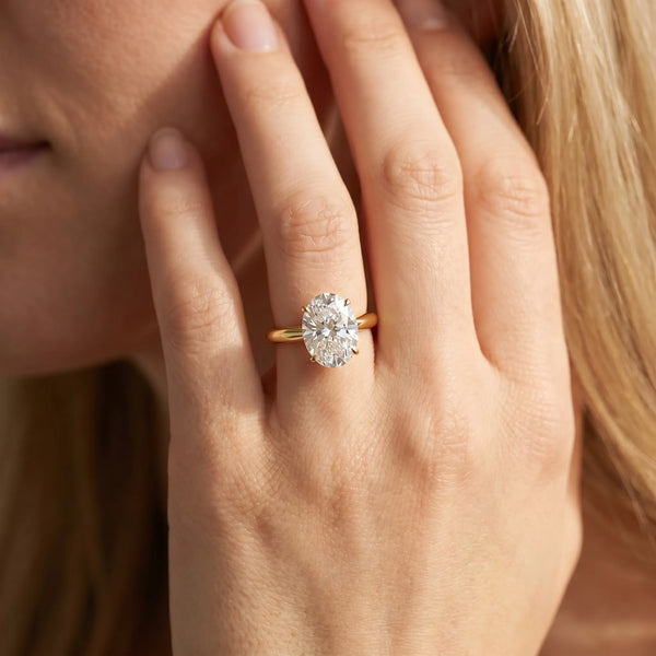 Yellow gold Oval Cut Diamond Solitaire Engagement Ring with Cathedral Setting and Four-Prong Mount