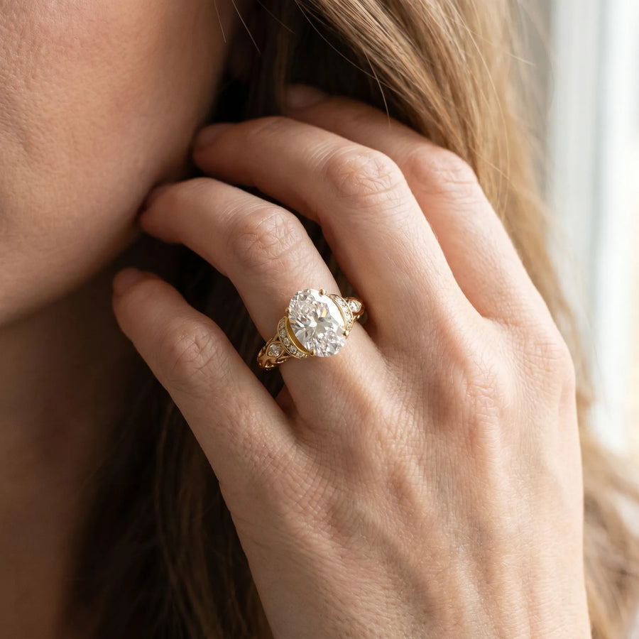 Yellow gold Oval Cut Diamond Solitaire Ring with Filigree Band and Four-Prong Setting