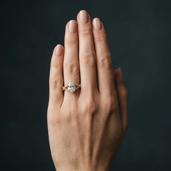 Yellow gold Oval Cut Diamond Solitaire Ring with Four-Prong Setting and Twisted Pavé Band