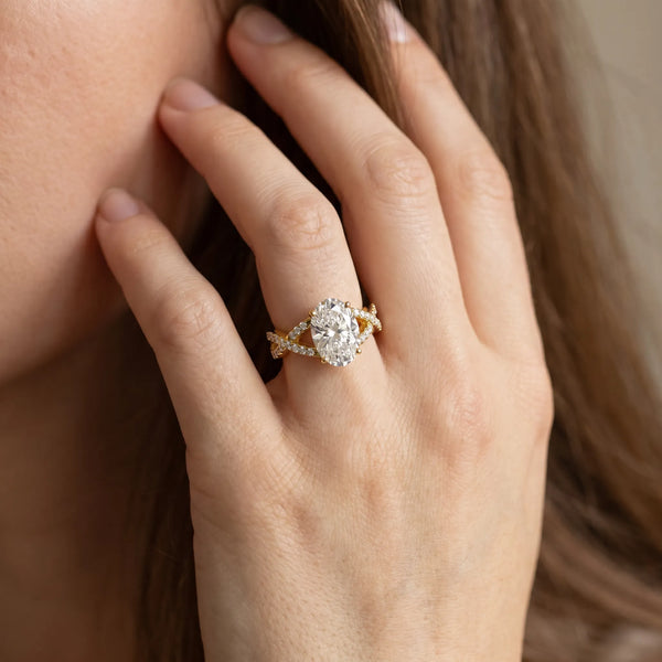 Yellow gold Oval Cut Diamond Solitaire Ring with Four-Prong Setting and Twisted Pavé Band