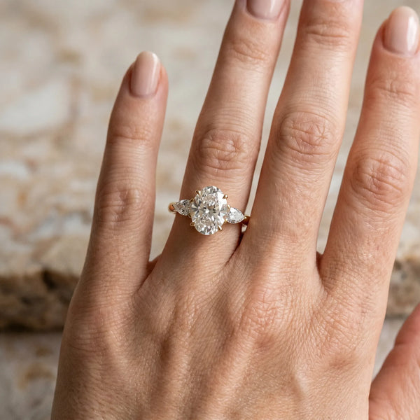 14K Yellow Gold 1.16 Carat D VVS2 Oval Diamond Three-Stone Ring with Pear Side Stones and Prong Setting