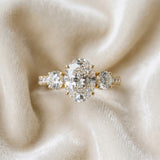Yellow gold Oval Cut Diamond Three-Stone Ring with Round Side Stones and Pavé Band_131