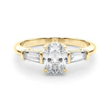 Yellow gold Oval Cut Diamond Three-Stone Ring with Tapered Baguette Side Stones and Prong Setting 1