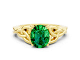 Yellow gold Oval Cut Emerald Solitaire Engagement Ring with Celtic Knot Band and Four-Prong Setting