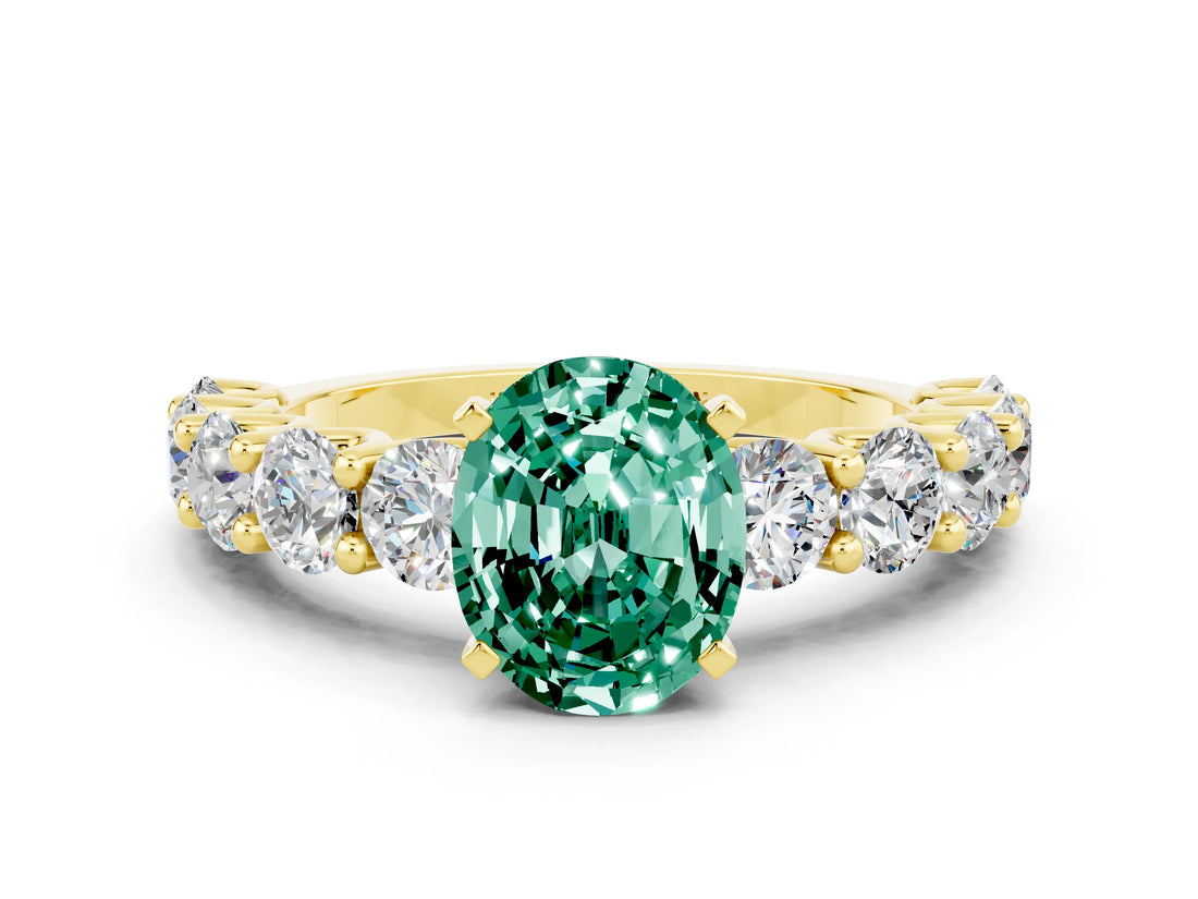 Yellow gold Oval Cut Green Sapphire Prong Setting with Side Stones on a Pave Band