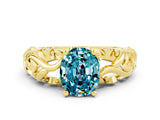 Yellow gold Oval Cut Solitaire Blue Topaz Leaf-Inspired Vine Band Ring with Prong Setting