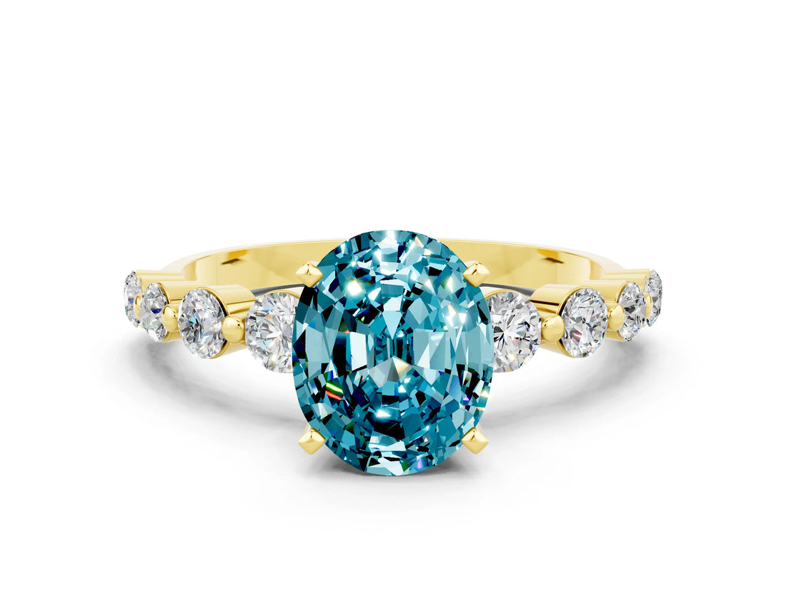 Yellow gold Oval Cut Solitaire Blue Topaz Ring with Pave Band and Four-Prong Setting