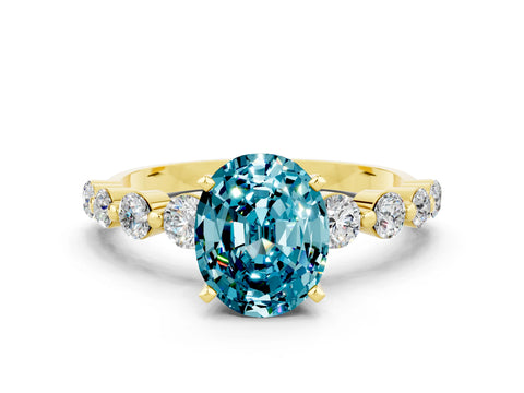 Yellow gold Oval Cut Solitaire Blue Topaz Ring with Pave Band and Four-Prong Setting