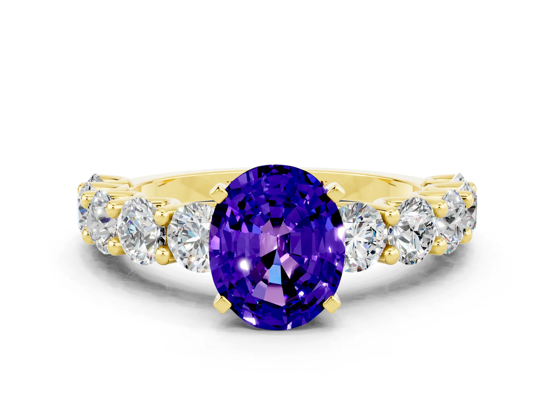 Yellow gold Oval Cut Tanzanite Prong Setting with Side Stones on a Pave Band