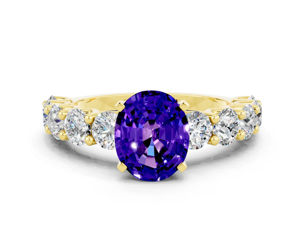 Yellow gold Oval Cut Tanzanite Prong Setting with Side Stones on a Pave Band