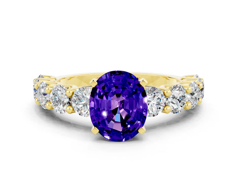 Yellow gold Oval Cut Tanzanite Prong Setting with Side Stones on a Pave Band